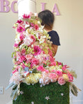 4.5 feet tall floral arrangement. Floral Fountain flowing down from a box. Pink floating arrangement. 