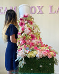 4.5 feet tall floral arrangement. Floral Fountain flowing down from a box. Pink floating arrangement. 